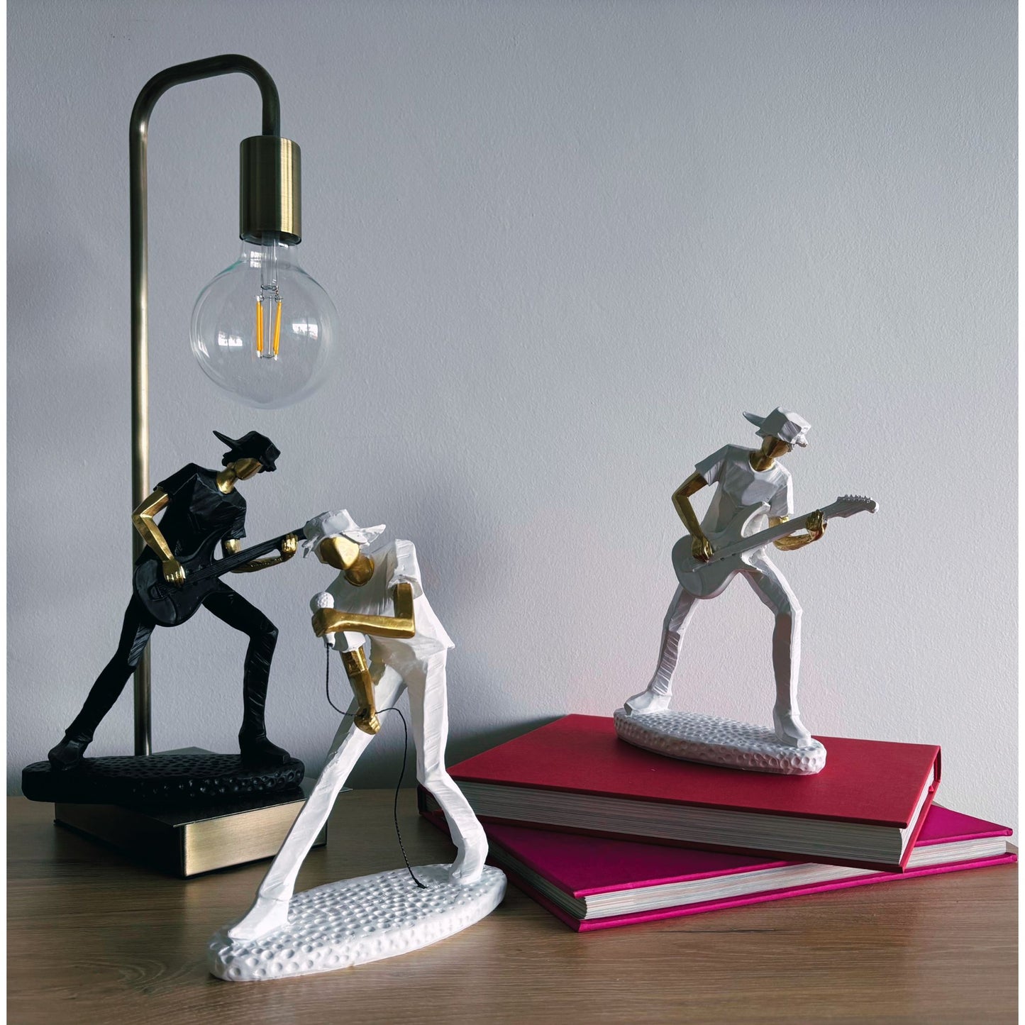 Decorative table lamp with musician figurines on a wooden surface