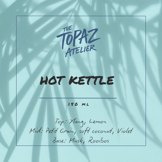 Product label for 'Hot Kettle' by The Topaz Atelier with leaf shadows on a light blue background.