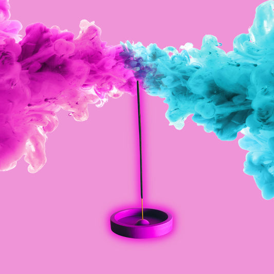 purple incense burner with pink and blue smoke on pink background
