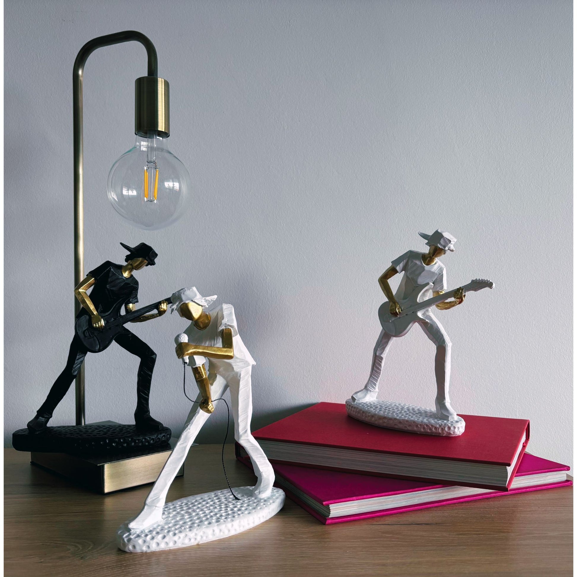 Decorative table lamp with musician figurines on a wooden surface